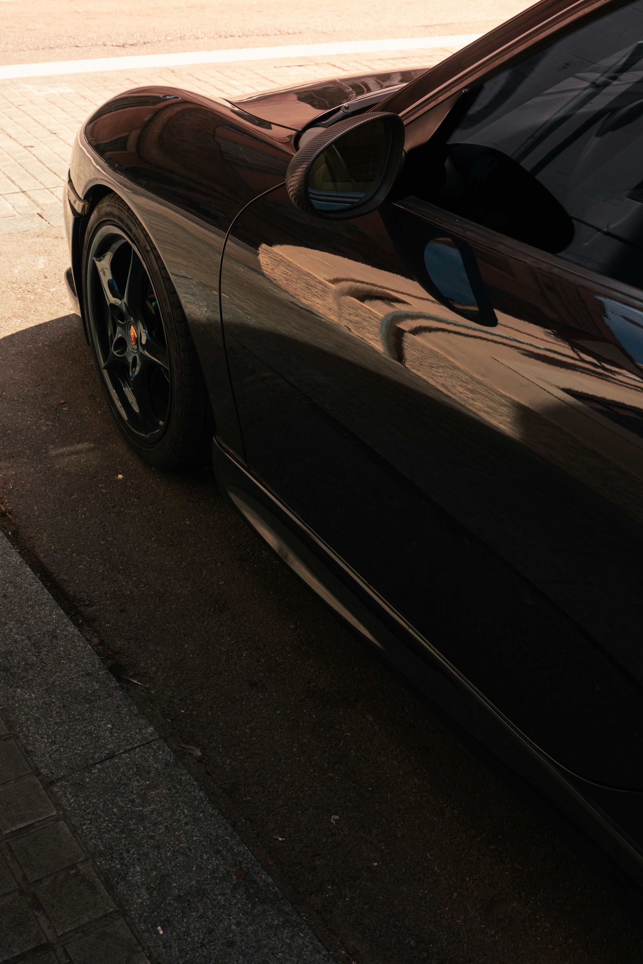 Black performance car in a dark studio